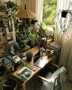 an office with plants and books on the desk