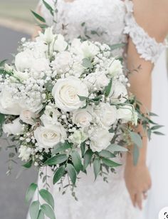 a bridal holding a bouquet of white flowers