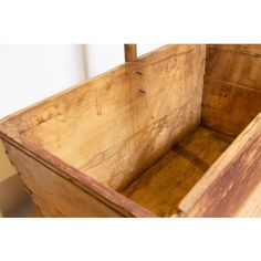 an old wooden box with no lid is shown in this image, it's empty