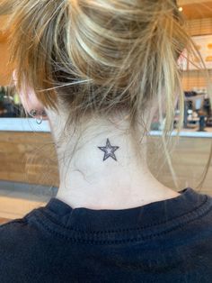 a woman with a small star tattoo on her neck