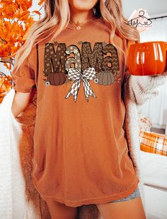 Comfort Colors® Fall Mama Coquette T-shirt, Fall Mama Shirt, Fall Season Tee, Pumpkin Mama Tee, Autumn Leaves, Fall Outfit, Gift For Mama Hello!! We wish everyone to smile with our cute, stylish, and trendy graphic T-shirts. We assure you these Comfort Colors® T-shirts are the perfect gifts whether you buy them for yourself or someone else. MATERIALS & FEATURES *6.1 oz., 100% ring spun cotton *Preshrunk, soft-washed, garment-dyed fabric *Twill taped shoulder-to-shoulder *Set-in sleeves *Double-needle stitched sleeves and bottom hem *1" ribbed collar with double-needle top stitched neckline HOW TO ORDER *Check the size chart and pick your size. *Check the color chart and pick your t-shirt color.  If you wish the trendy oversized look, please choose 2 size up from the normal size you prefer Mama Tee, Mama T Shirt, Leaves Fall, Mama Shirts, Dyed Fabric, Mama Shirt, Fall Outfit, Twill Tape, Fall Season