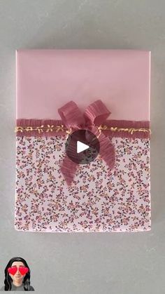 a pink gift box with a bow on it