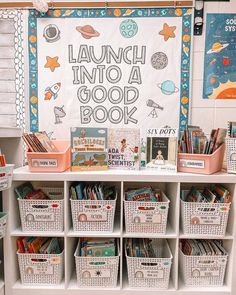 a book shelf with baskets and books on it in front of a sign that reads launch into a good book