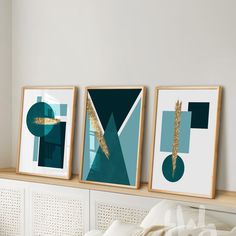 three framed art pieces on a wall above a bed