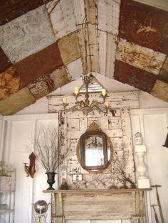 a room with a fireplace, mirror and decorative items