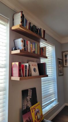 the bookshelves in this room are full of books and have been placed on top of each other