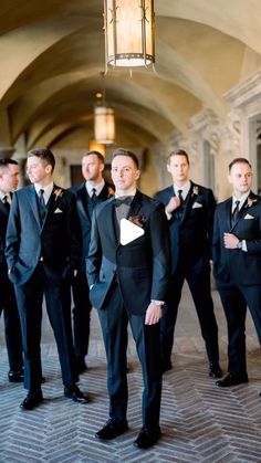 a group of men in tuxedos standing next to each other