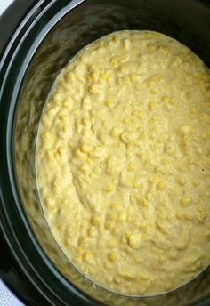 a bowl filled with macaroni and cheese sitting on top of a stovetop