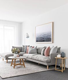 a living room filled with furniture and a large painting hanging on the wall above it