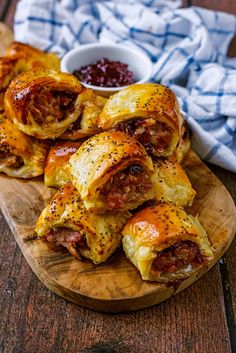 sausage wrapped in puff pastry on a wooden platter