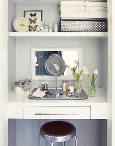 there is a sink in the corner of this room with white walls and shelves above it