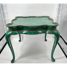 a green table with gold trimmings on the top and bottom, sitting in front of a white background