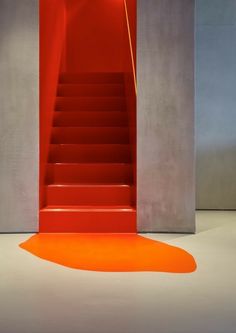 a red staircase leading up to an orange floor