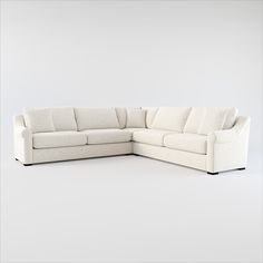 a white sectional couch sitting on top of a white floor