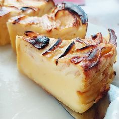 two pieces of cheese sitting on top of a white plate