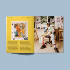 a man sitting in a chair next to a yellow book with pictures on the cover