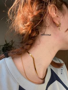 a woman with a tattoo on her neck