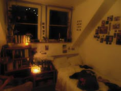 a bed sitting in a bedroom under a window next to a book shelf filled with books