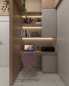 a computer desk with a laptop on top of it in front of a book shelf