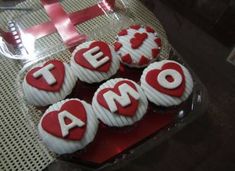 red and white decorated cupcakes with the word amo spelled out on them