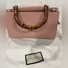 New Gucci Pink Calfskin Nymphaea Top Handle Bag Gold Hardware The Interior Is Lined In A Grey Suede Textile Material Includes Care Booklets And Strap Made In Italy Chic Handheld Gucci Bag, Gucci Pink Shoulder Bag With Detachable Handle, Pink Gucci Bag With Detachable Handle, Gucci Shoulder Bag With Bamboo Handle For Shopping, Chic Gucci Handheld Shoulder Bag, Chic Handheld Gucci Shoulder Bag, Chic Gucci Shoulder Bag With Bamboo Handle, Gucci Designer Bag With Bamboo Handle, Gucci Pink Luxury Shoulder Bag