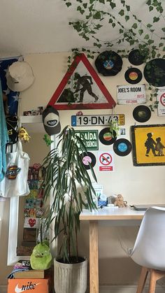 a room filled with lots of different types of signs on the wall and plants in pots