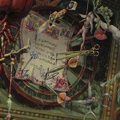 a clock with many items attached to it's face and some writing on the front