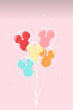 mickey mouse balloons floating in the air with stars and sparkles around them on a pink background