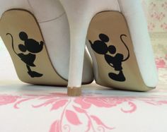 a pair of white high heels with mickey mouse on them