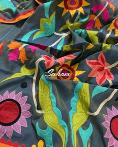 the colorful fabric has flowers and leaves on it