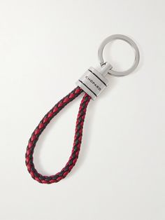 a red and black braided keychain on a white background