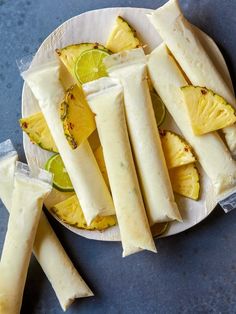 some food is sitting on a plate with lemons and lime slices around it, ready to be eaten