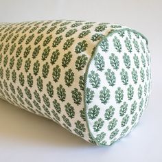 a green and white pillow sitting on top of a table