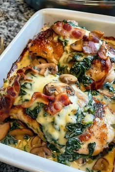 a casserole dish with chicken, spinach and mushrooms