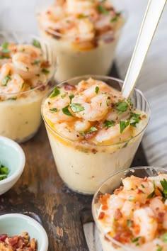 several small cups filled with food on top of a wooden table