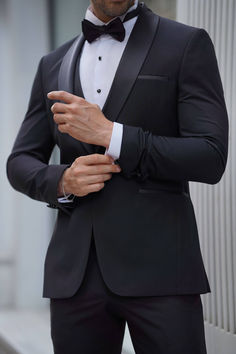 Elevate your style with our Slim Fit Shawl Collar Black Tuxedo Suit. Make a lasting impression at any formal occasion with this timeless and sophisticated ensemble. From Suitharbor's Spring Summer Collection. Crafted from a luxurious blend of 80% Wool and 20% Polyester. This impeccably tailored suit boasts a sleek silhouette, featuring a Shawl collar, Double slit, Double Fleto Pocket, Single Button, and Full Lining for a polished look. Your package includes the Jacket, Vest, Pants, Shirt, Bow Tie, and Pocket Square. To keep this Black Tuxedo Suit in premium condition, Dry clean only. Ensure the perfect fit by providing your height and weight during purchase, referencing our model's size for guidance. Groom Classic Suit, Black Tux Spring Wedding, Black And White Tuxedo Wedding, Wedding Suits Groom Classy, Grooms Tux Ideas, Black Wedding Suit For Groom, Black Wedding Groom, Black Wedding Tuxedo