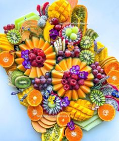 a bunch of different fruits and vegetables arranged in the shape of a flower on top of each other