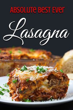 lasagna on a plate with parmesan cheese and bread in the background