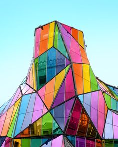 a multicolored building is shown against a blue sky