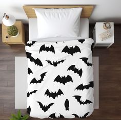 a bed with black and white bats on it