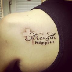 the back of a woman's shoulder with a tattoo saying strength and a cross