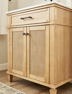 a bathroom vanity with wicker doors and drawers