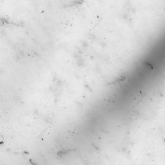 a black and white photo of the top of a marble countertop with small holes in it