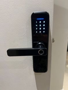 an electronic door lock on a white wall