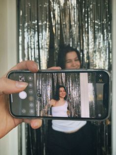 a woman taking a selfie with her cell phone