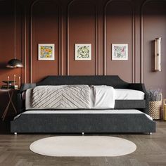 a living room with wood paneling and white rugs on the floor, including a black daybed