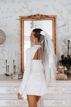 the back of a bride's dress in front of a mirror