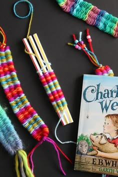 the book charlie west is laying next to some yarn and crochet hooks