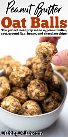 a hand is picking up some oat balls from a white bowl with chocolate chips