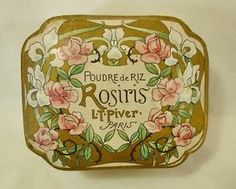 an old tin box with flowers painted on it